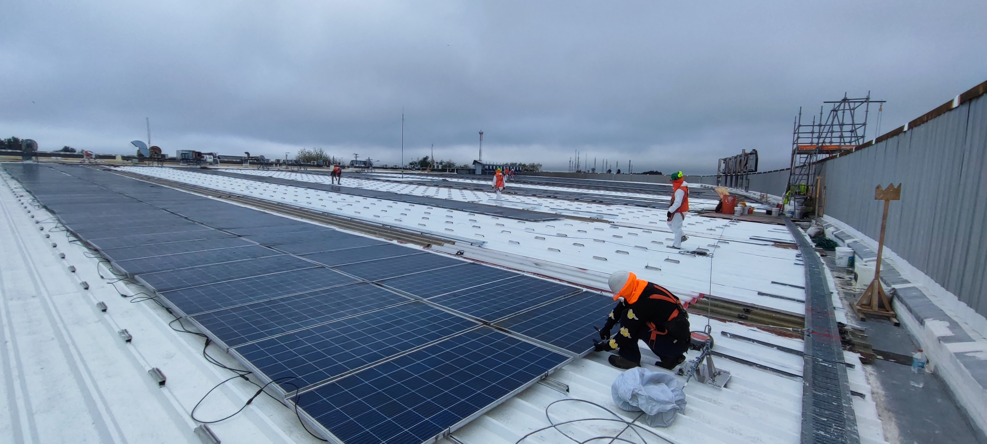 Técnicos ECOM ENERGY instalando paneles solares en faena